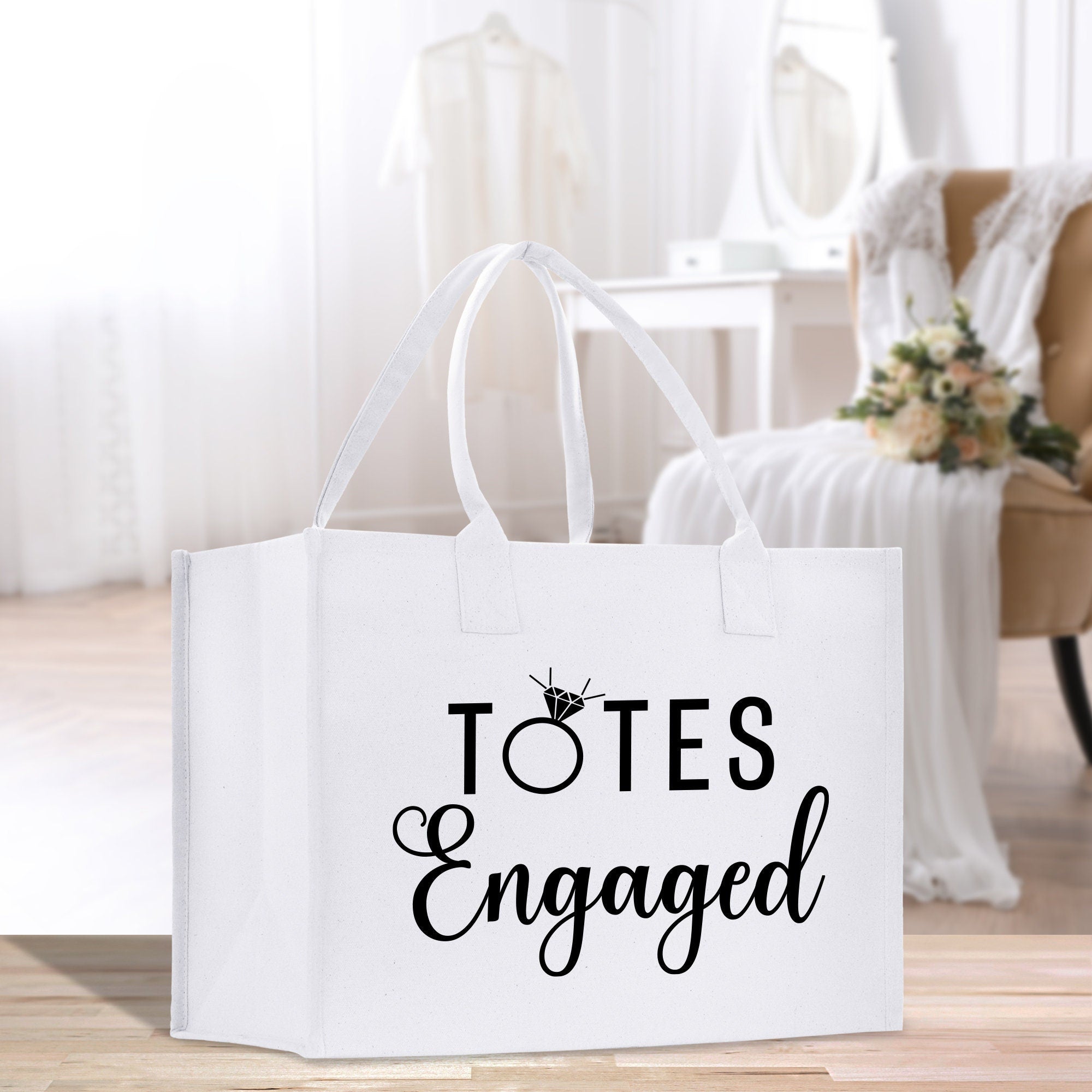 a white tote bag with the words totes engaged printed on it