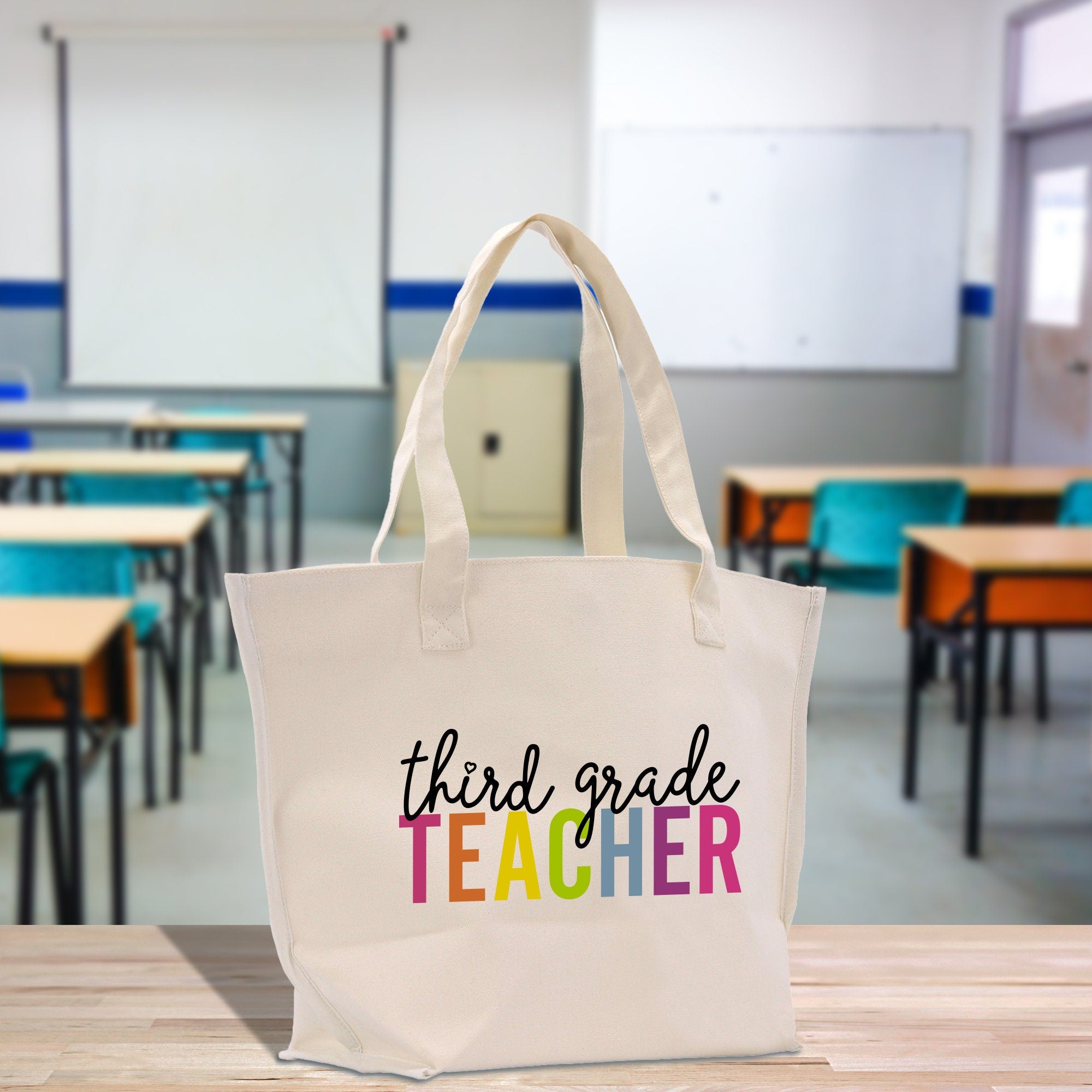a white bag that says third grade teacher on it