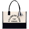 a black and white tote bag with a tassel