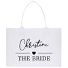 a white shopping bag with the words the bride printed on it