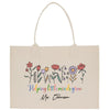 a white shopping bag with flowers and the words helping the minds grow