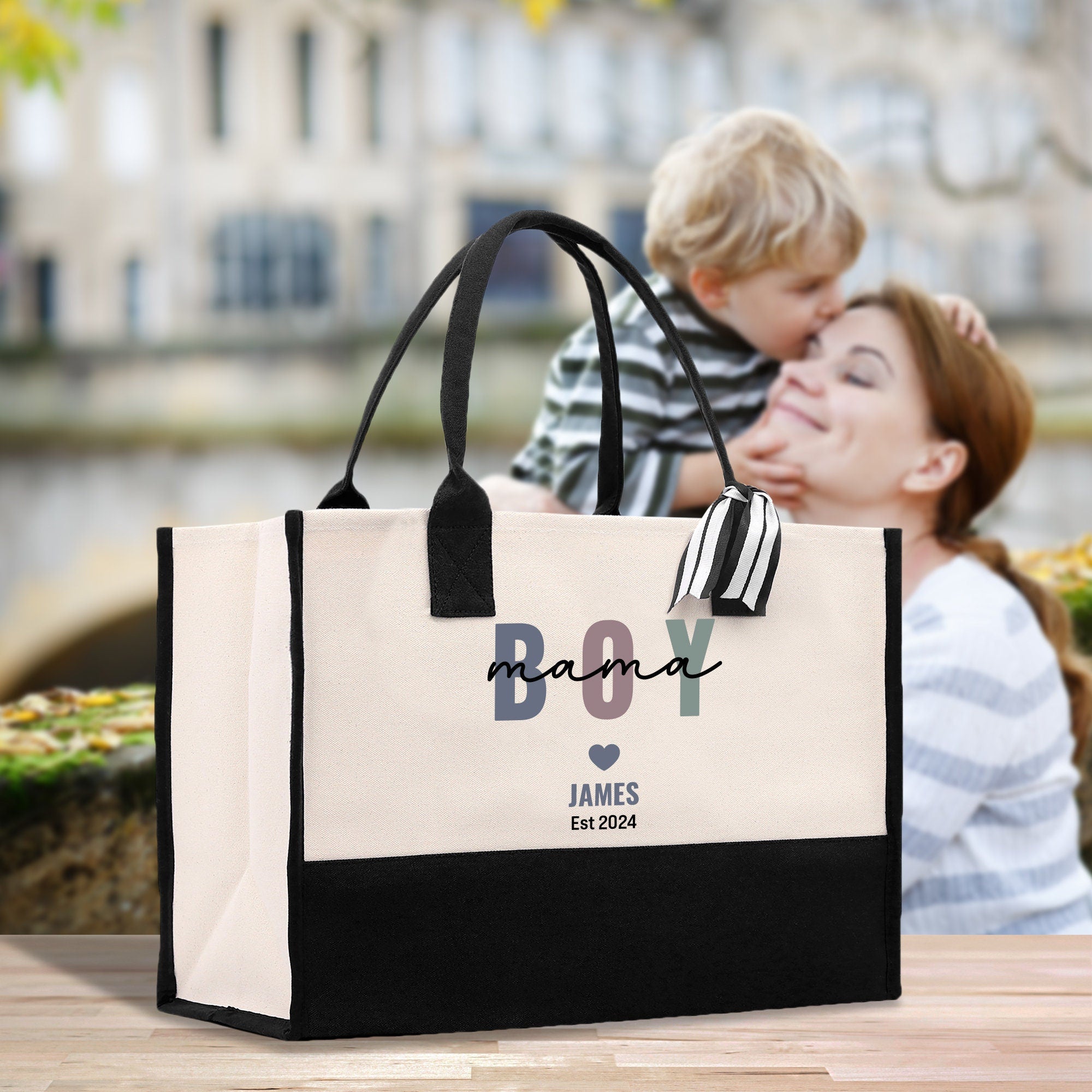 a woman holding a child in her arms while sitting in front of a bag