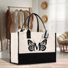 a black and white bag with a butterfly on it