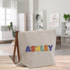 a canvas bag with the word astley painted on it