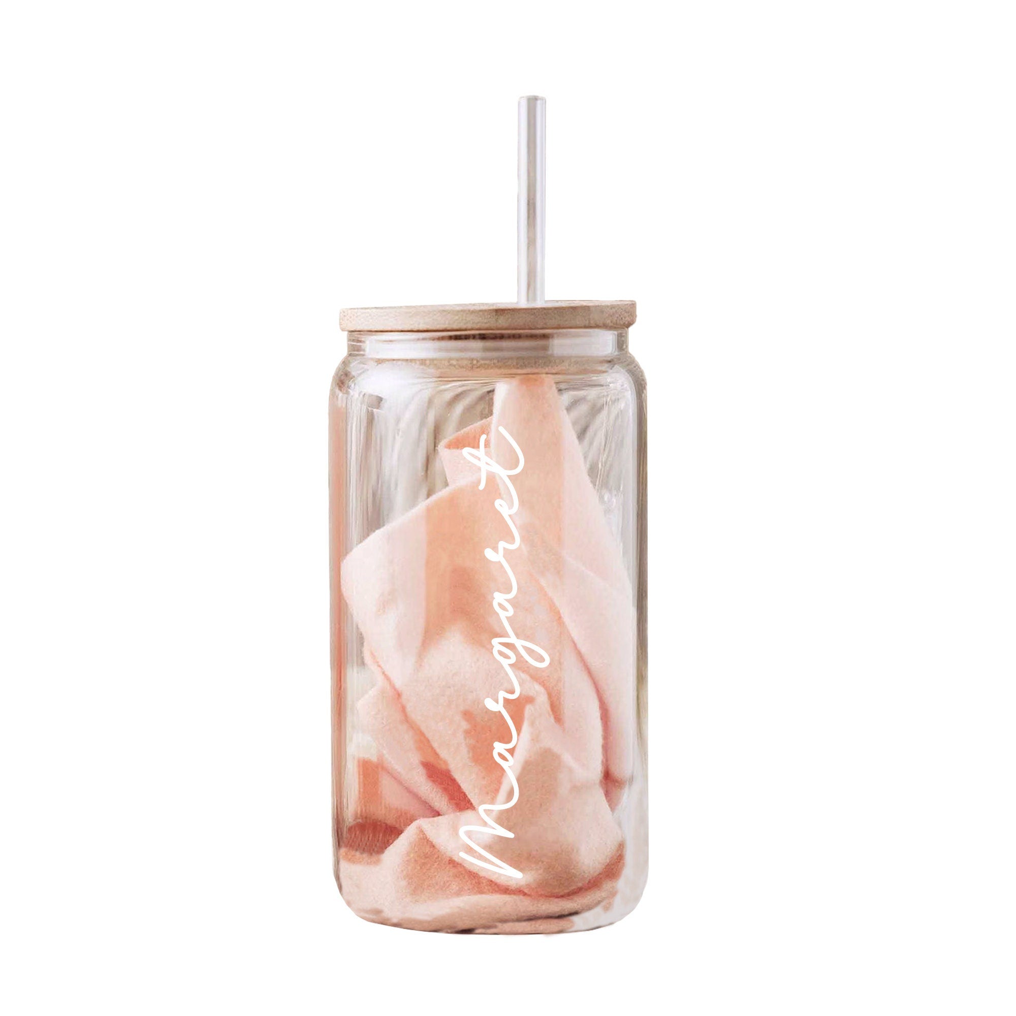 a glass jar with a pink towel in it