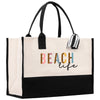 a white and black beach bag with a black handle