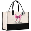 a black and white bag with a pink bow on it