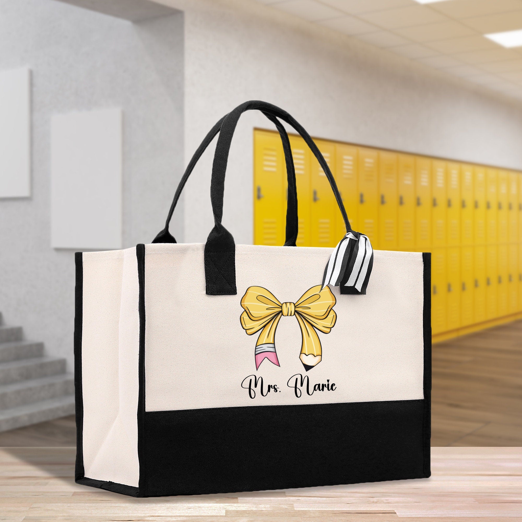 a black and white bag with a yellow bow on it