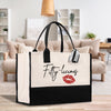 a black and white bag with a red lip on it