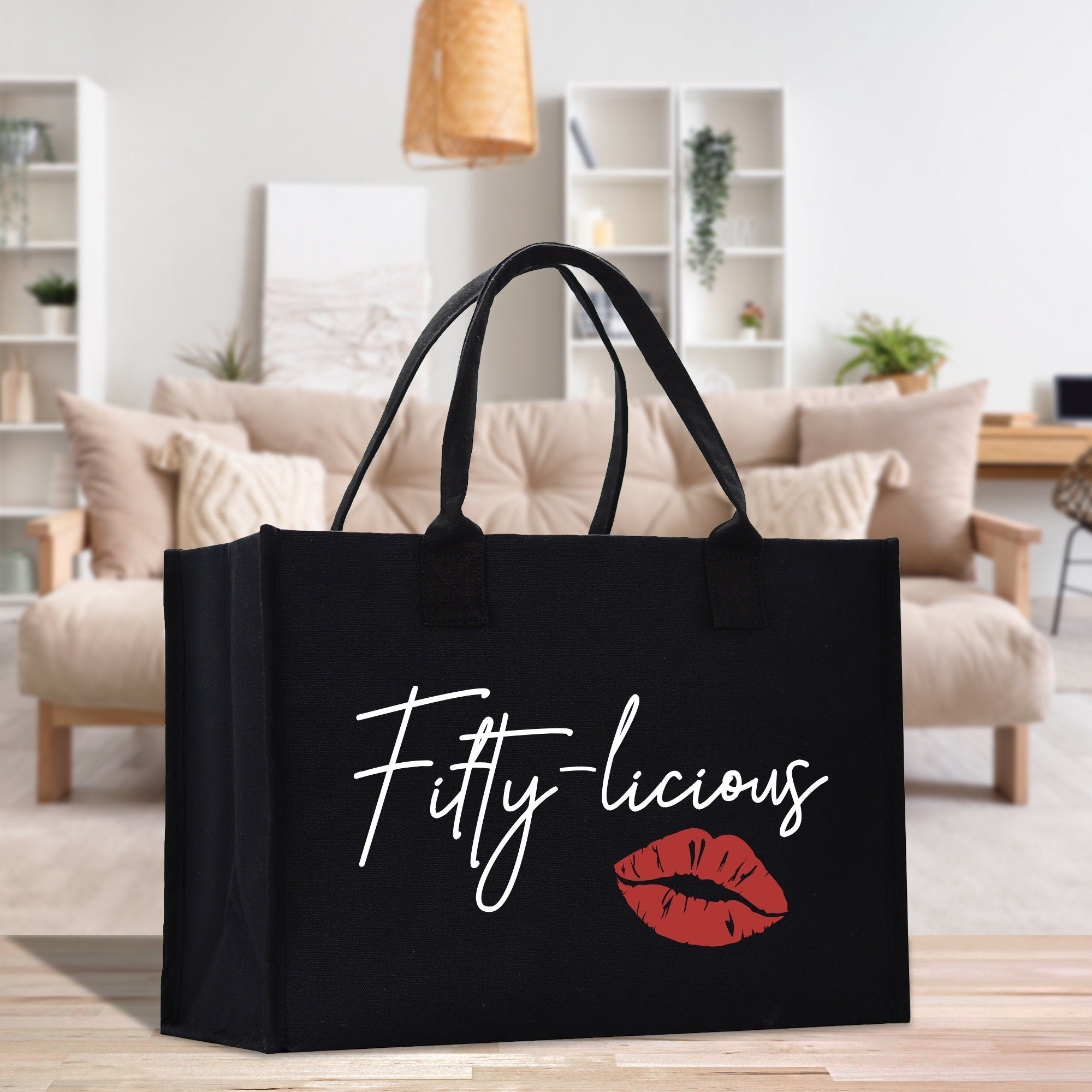 a black shopping bag with a red lip on it