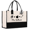 a black and white bag with a picture of a book and an apple