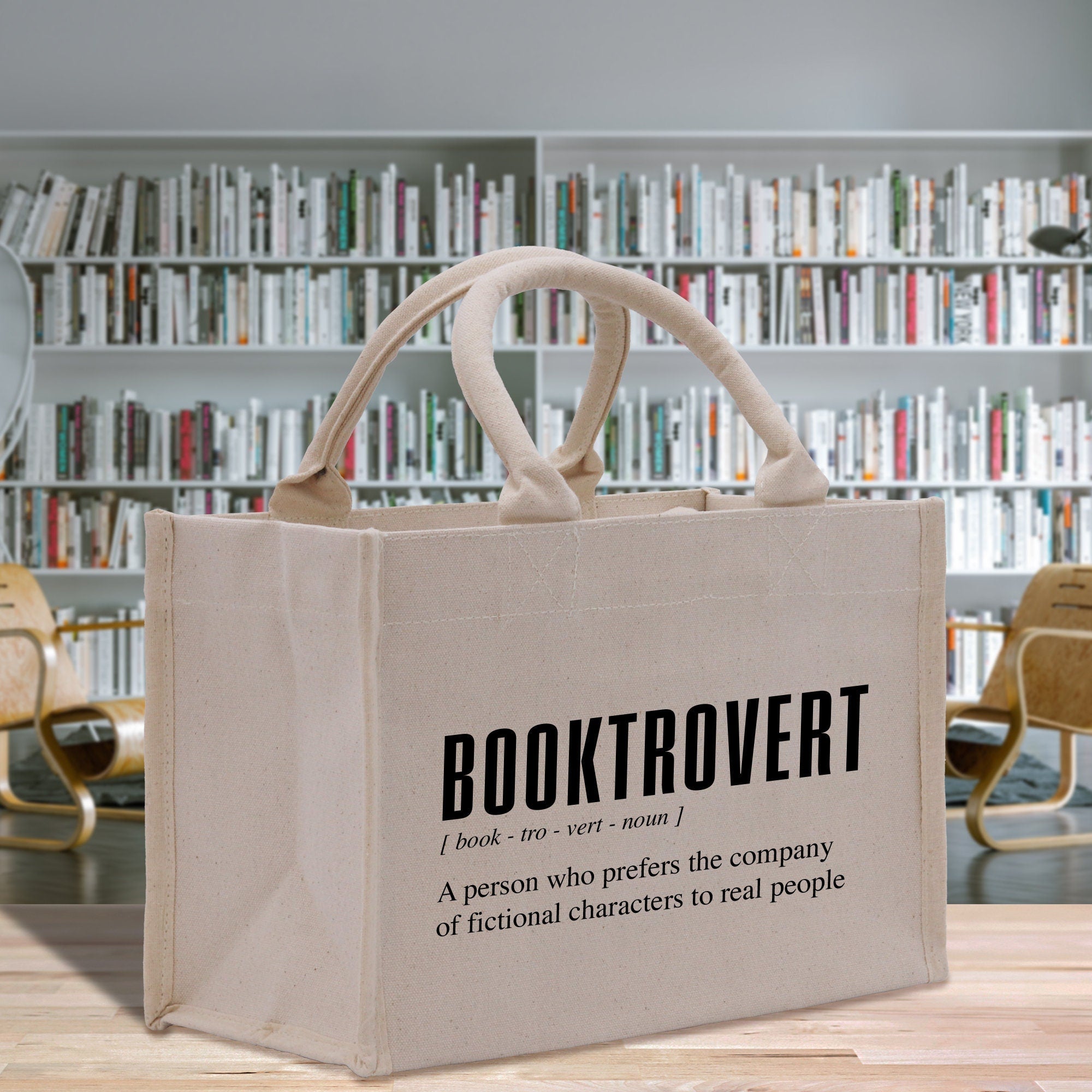 a book tote bag sitting on a table in front of a bookshelf