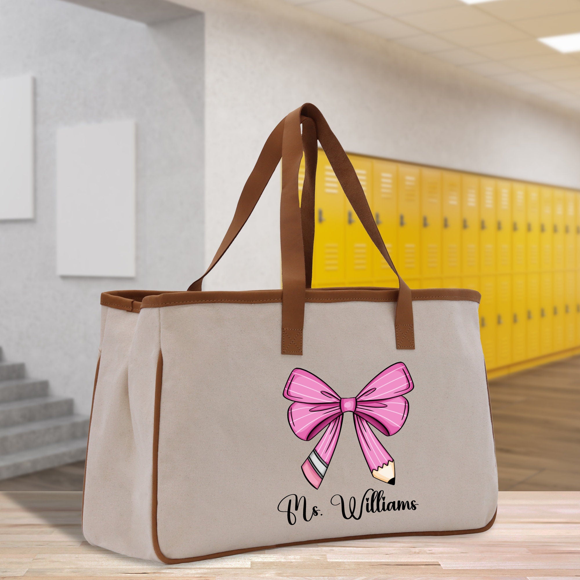 a canvas bag with a pink bow on it