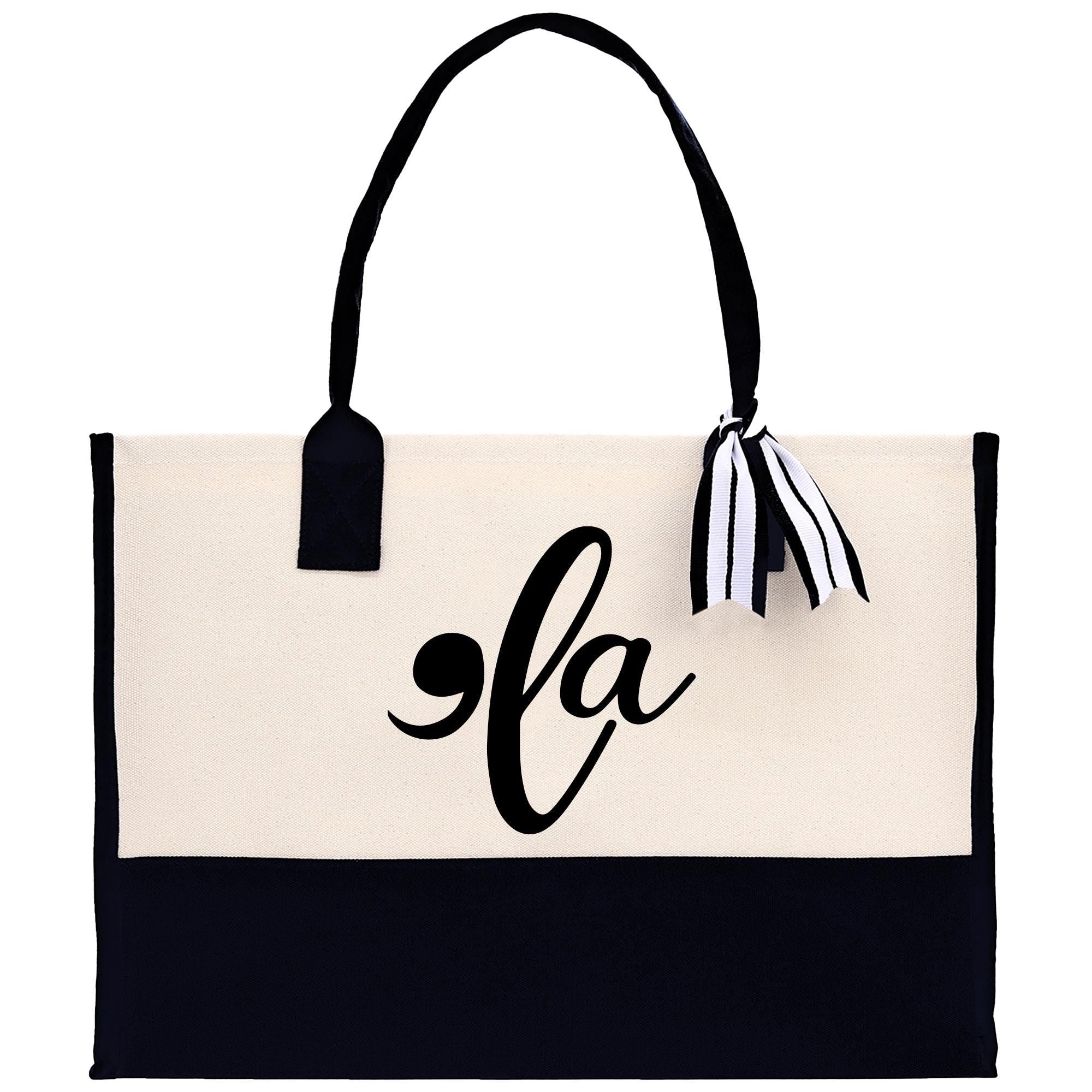 a black and white tote bag with the letter la on it