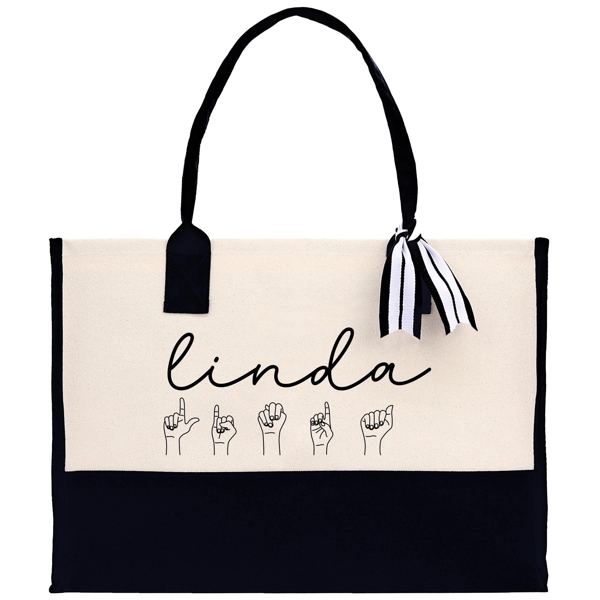 a black and white handbag with the word linda written on it