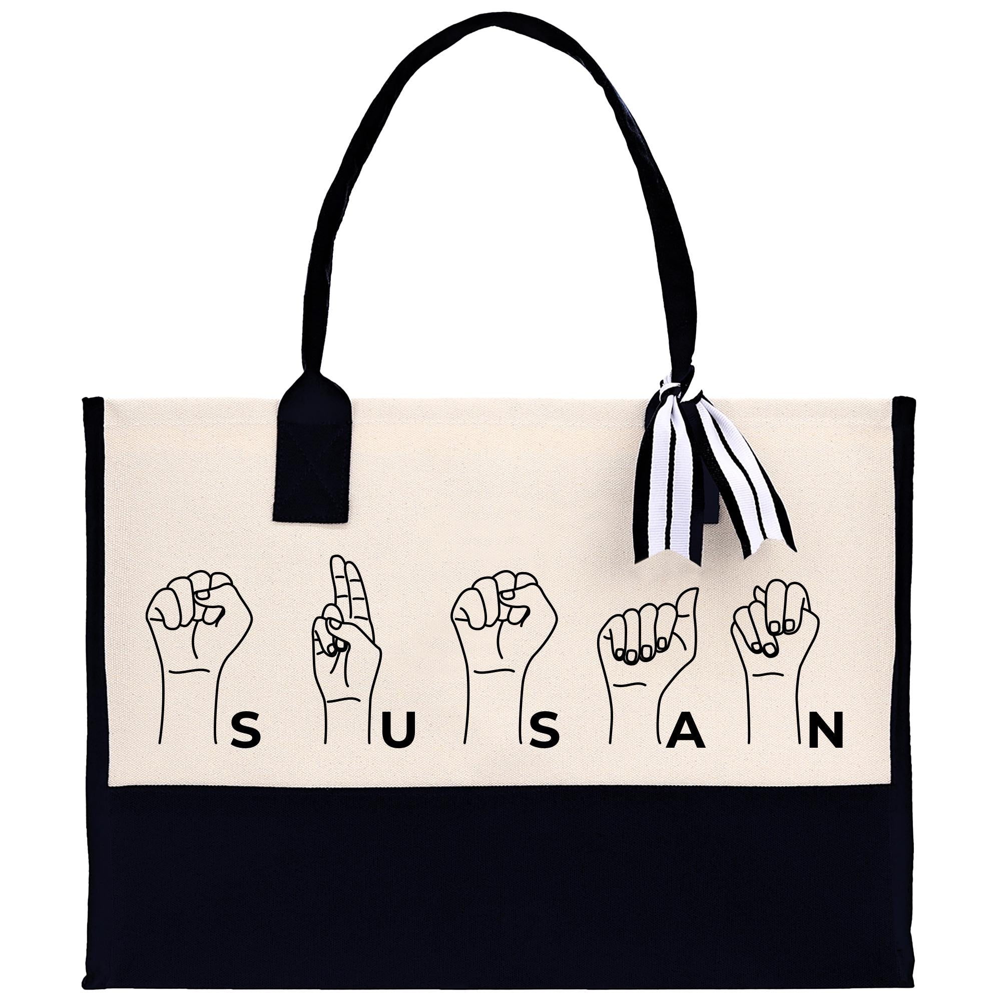 a black and white tote bag with a black and white ribbon hanging from it