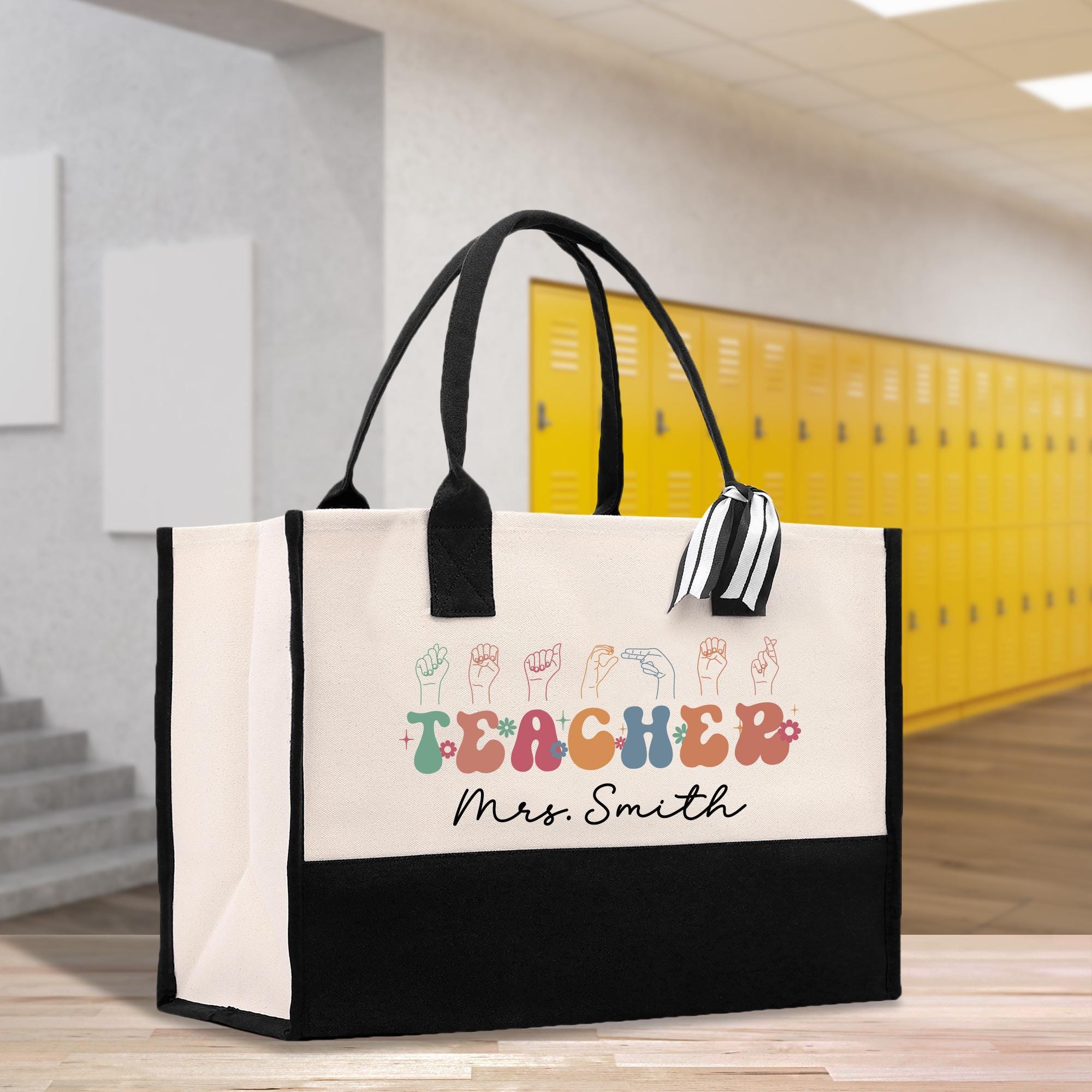 a black and white bag with a teacher&#39;s name on it