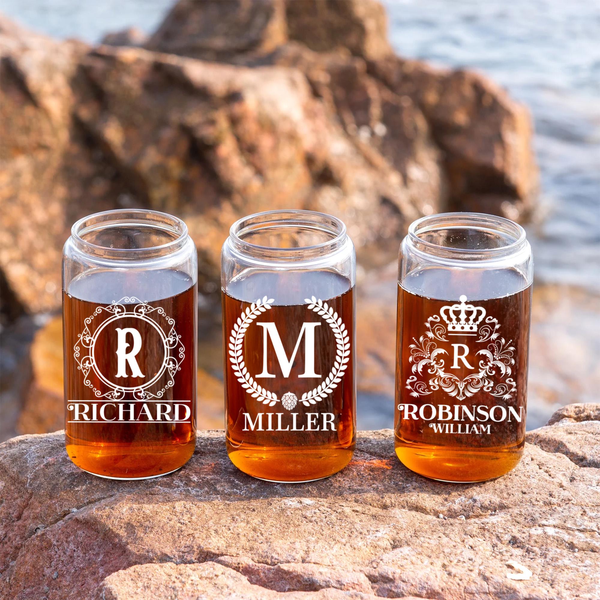 three jars of honey sitting on top of a rock