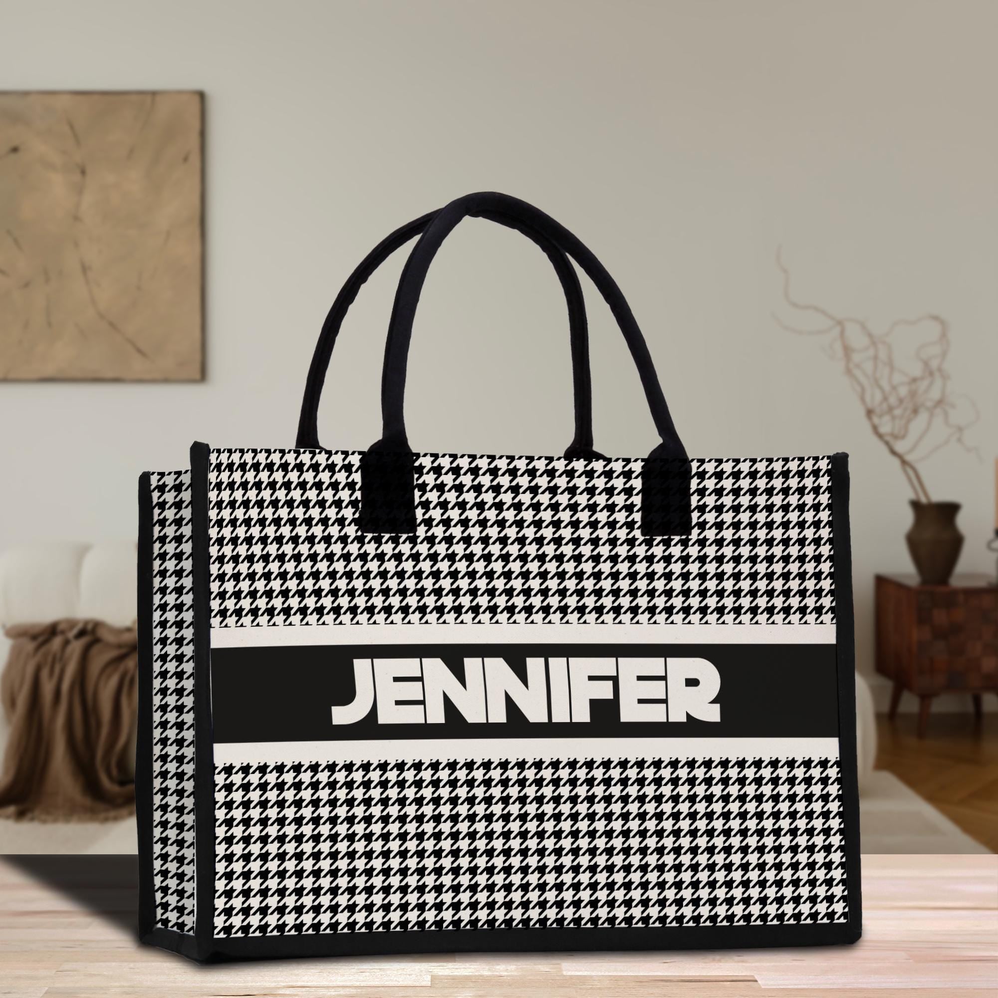 a black and white bag sitting on top of a wooden table