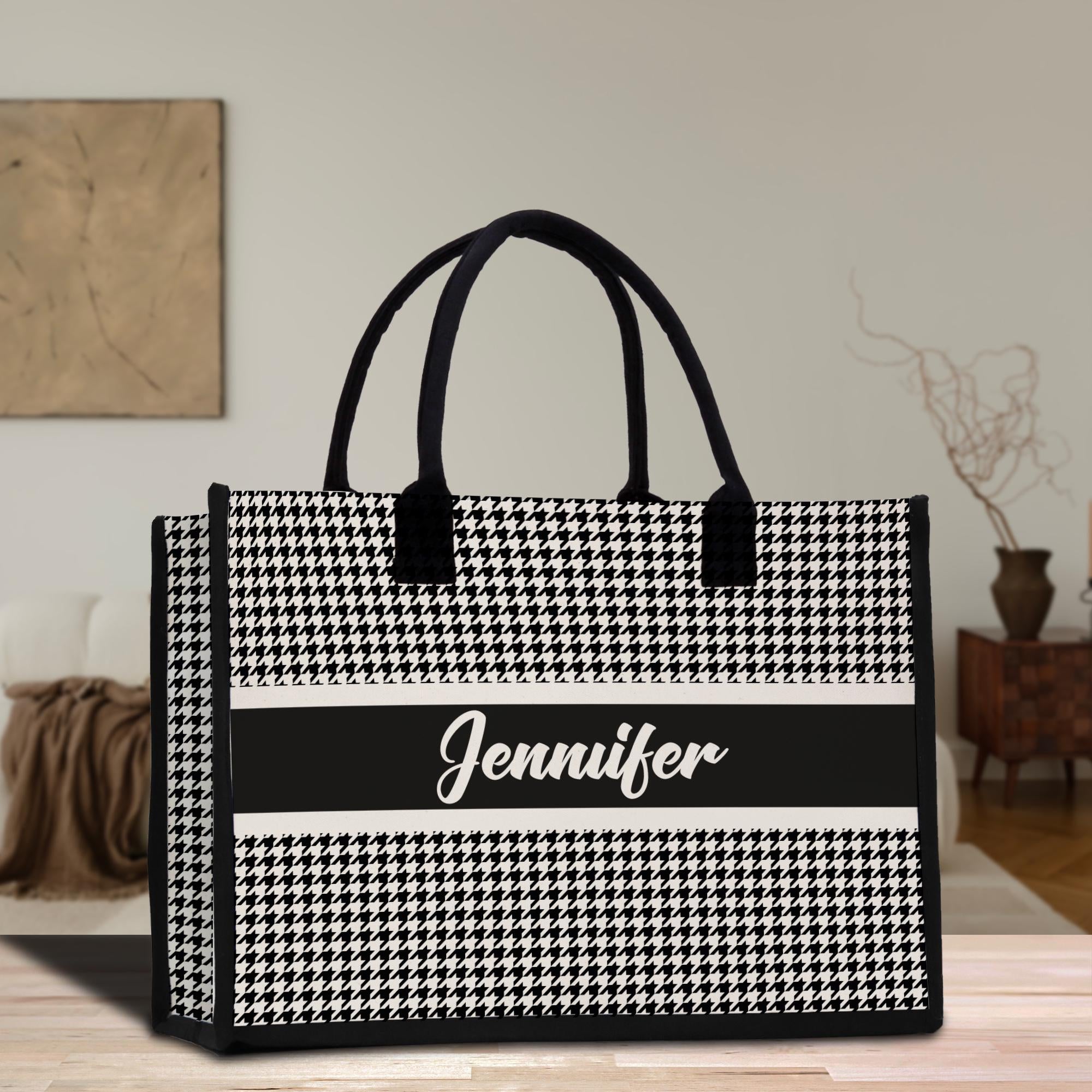 a black and white bag sitting on top of a wooden table