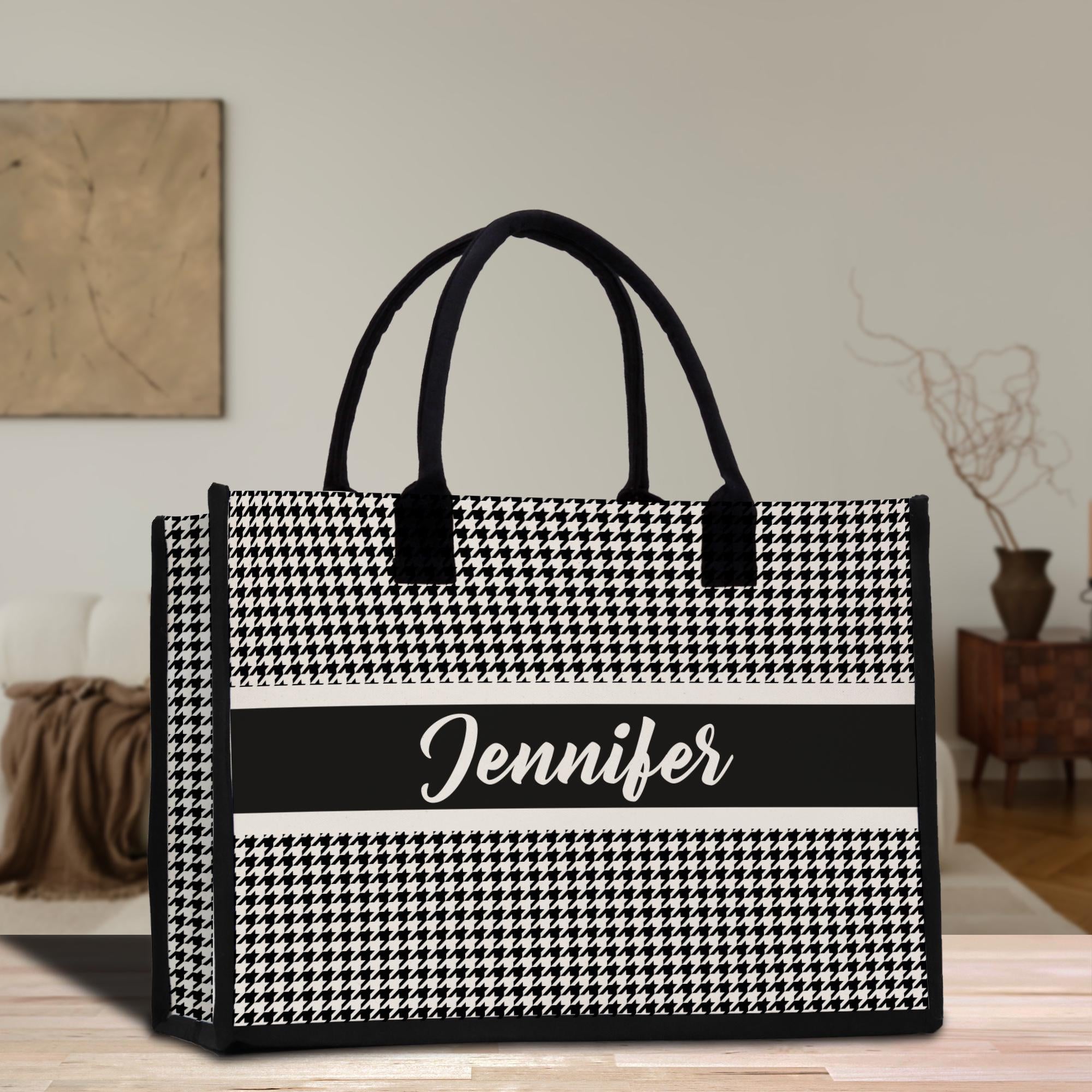 a black and white bag sitting on top of a wooden table