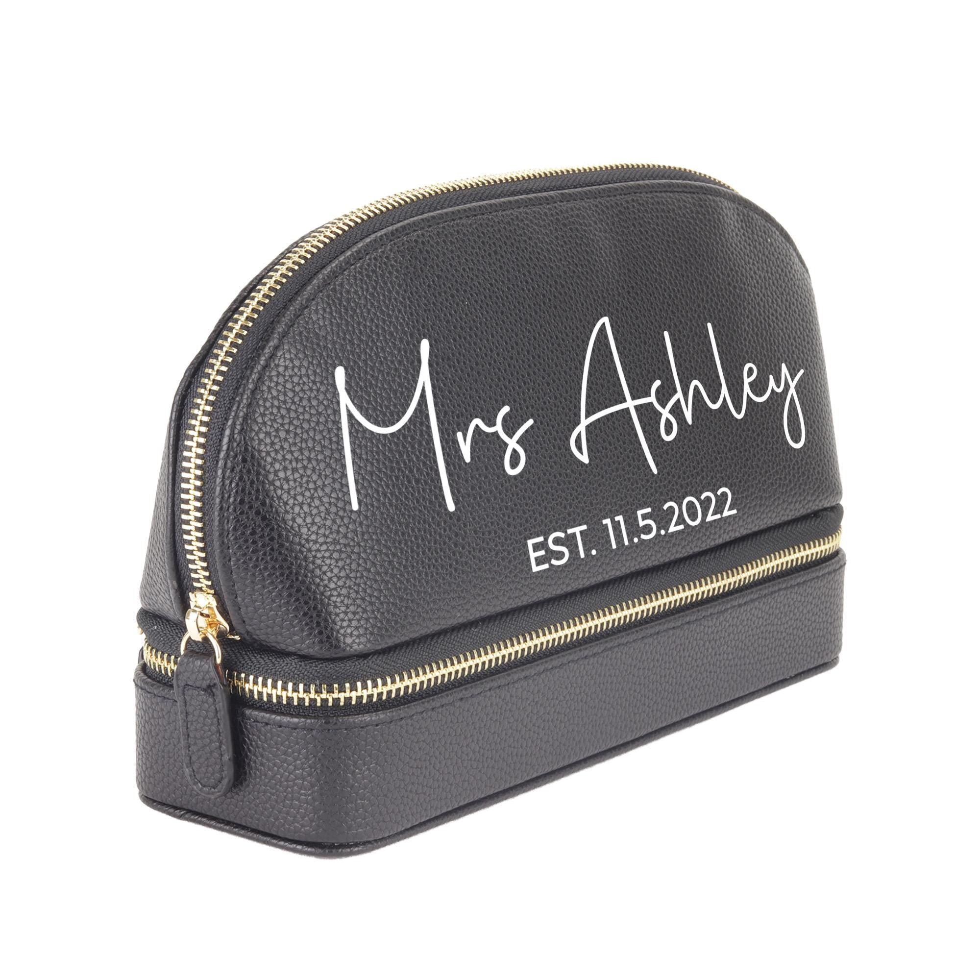 a black cosmetic bag with a name on it