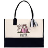 a black and white tote bag with a picture of a cat reading a book