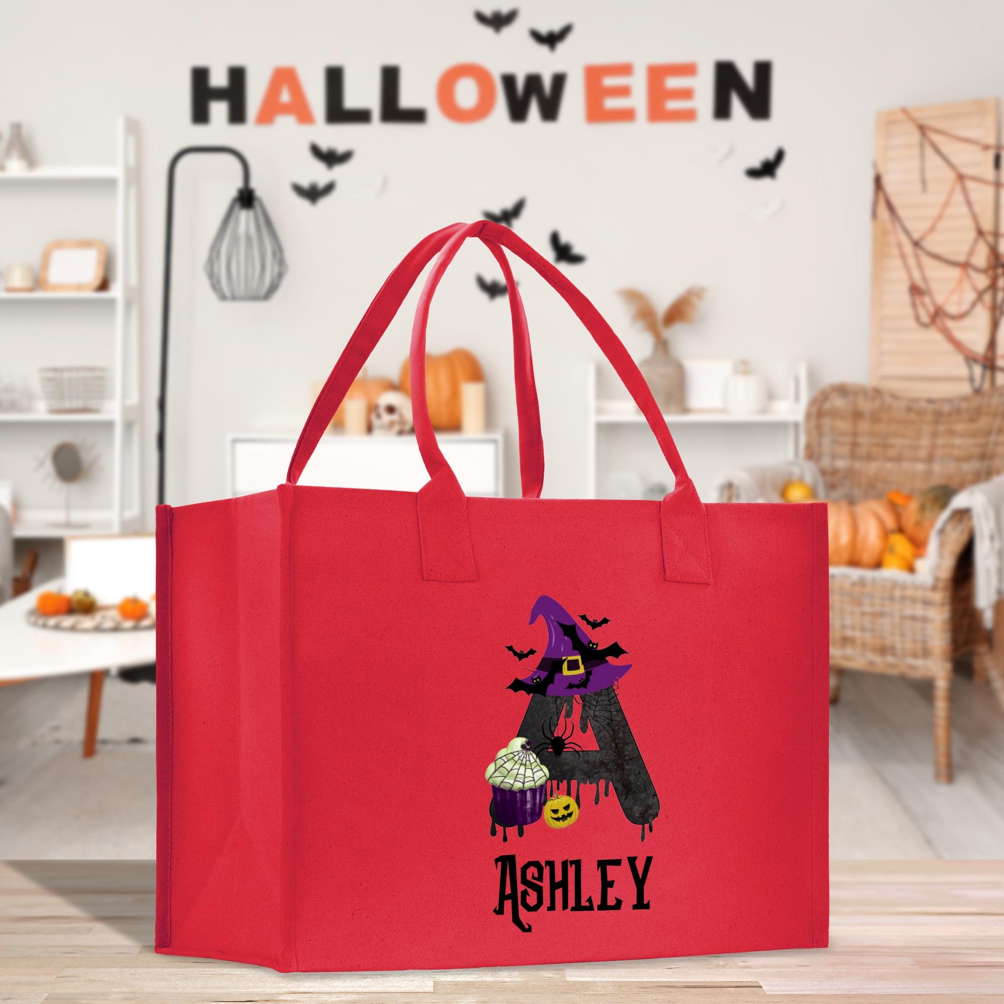 a red shopping bag with a picture of a witch on it