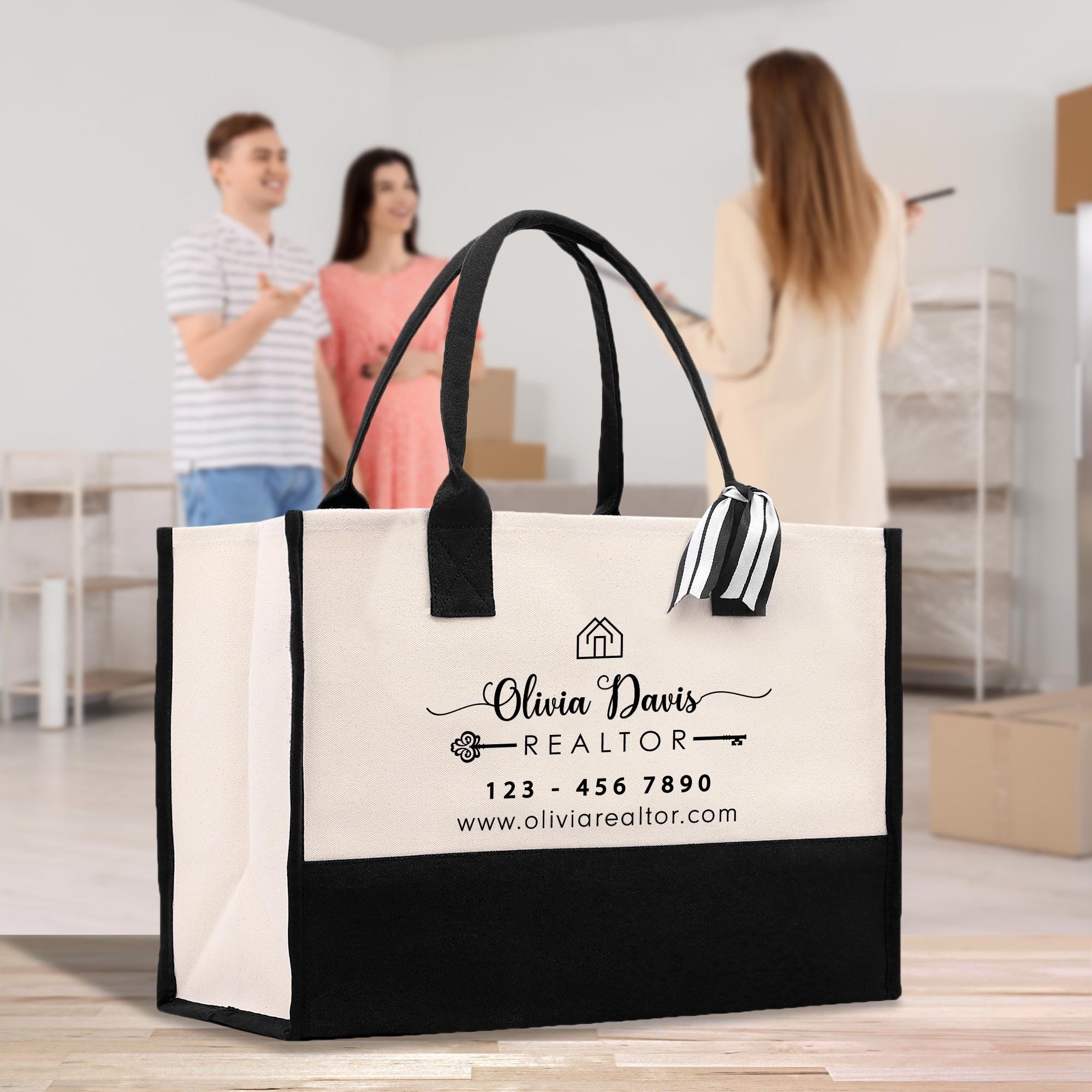 a woman and a man standing behind a black and white bag