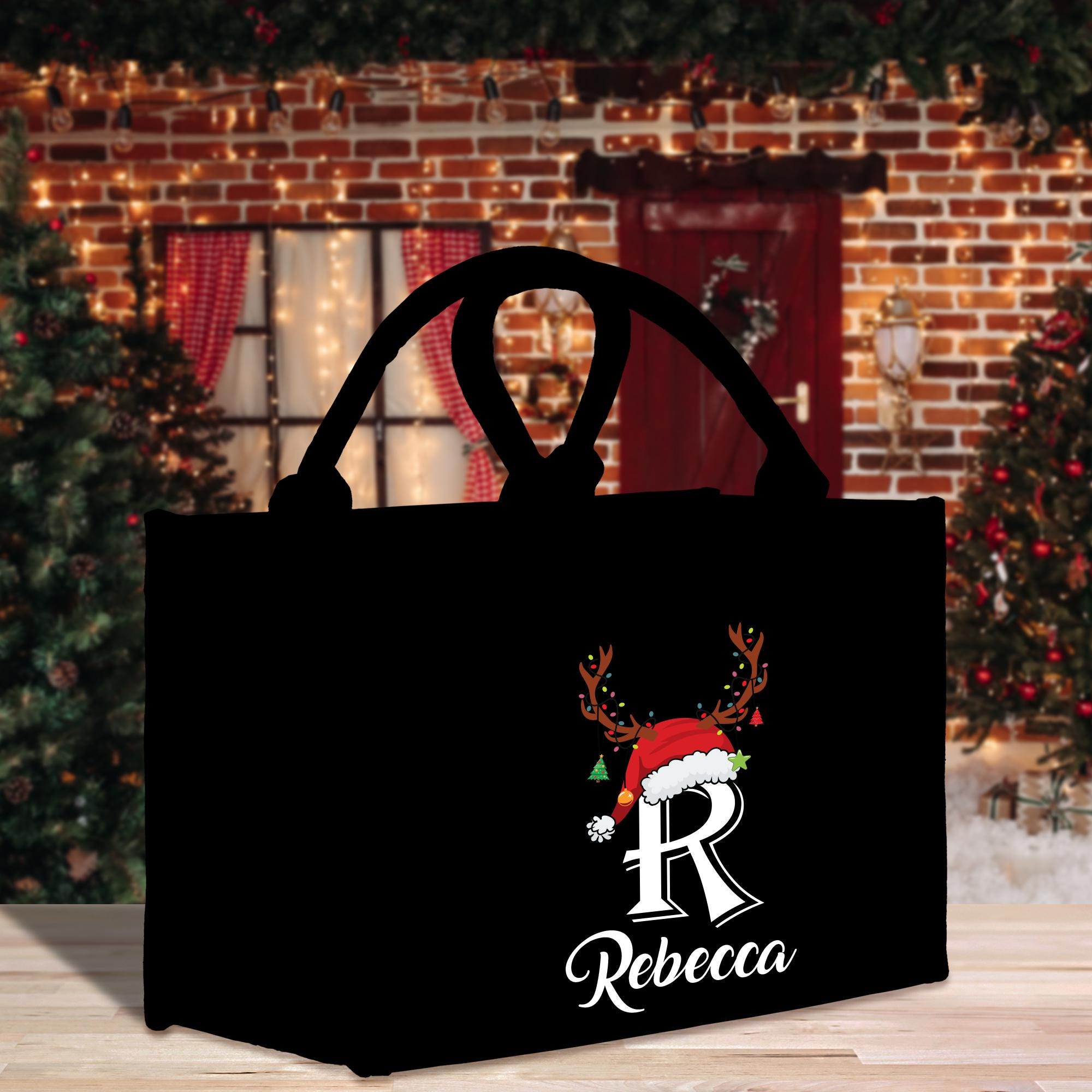 a black shopping bag with a reindeer head on it