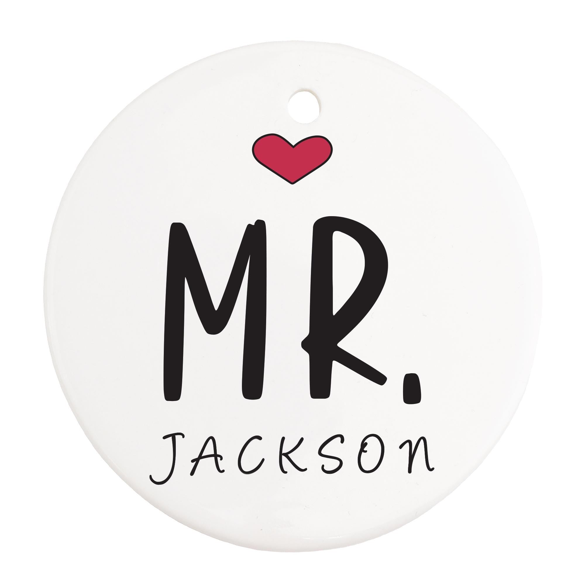 a white ornament with the word mr and a heart