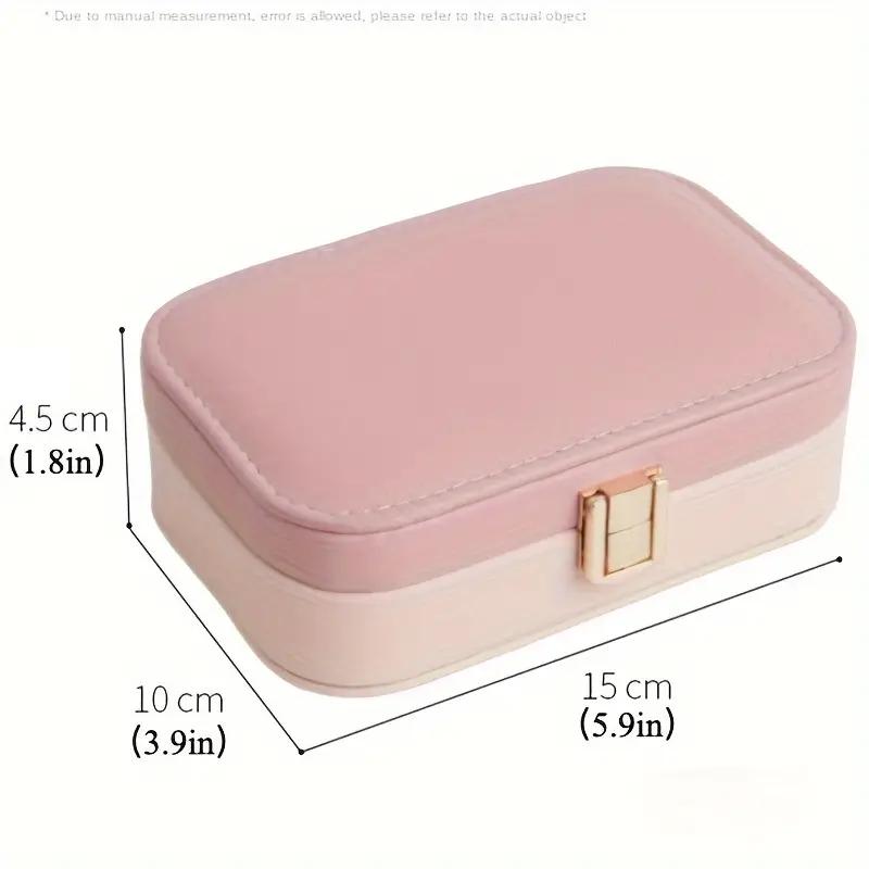 a small pink box with a gold handle