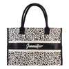 a leopard print bag with a name on it