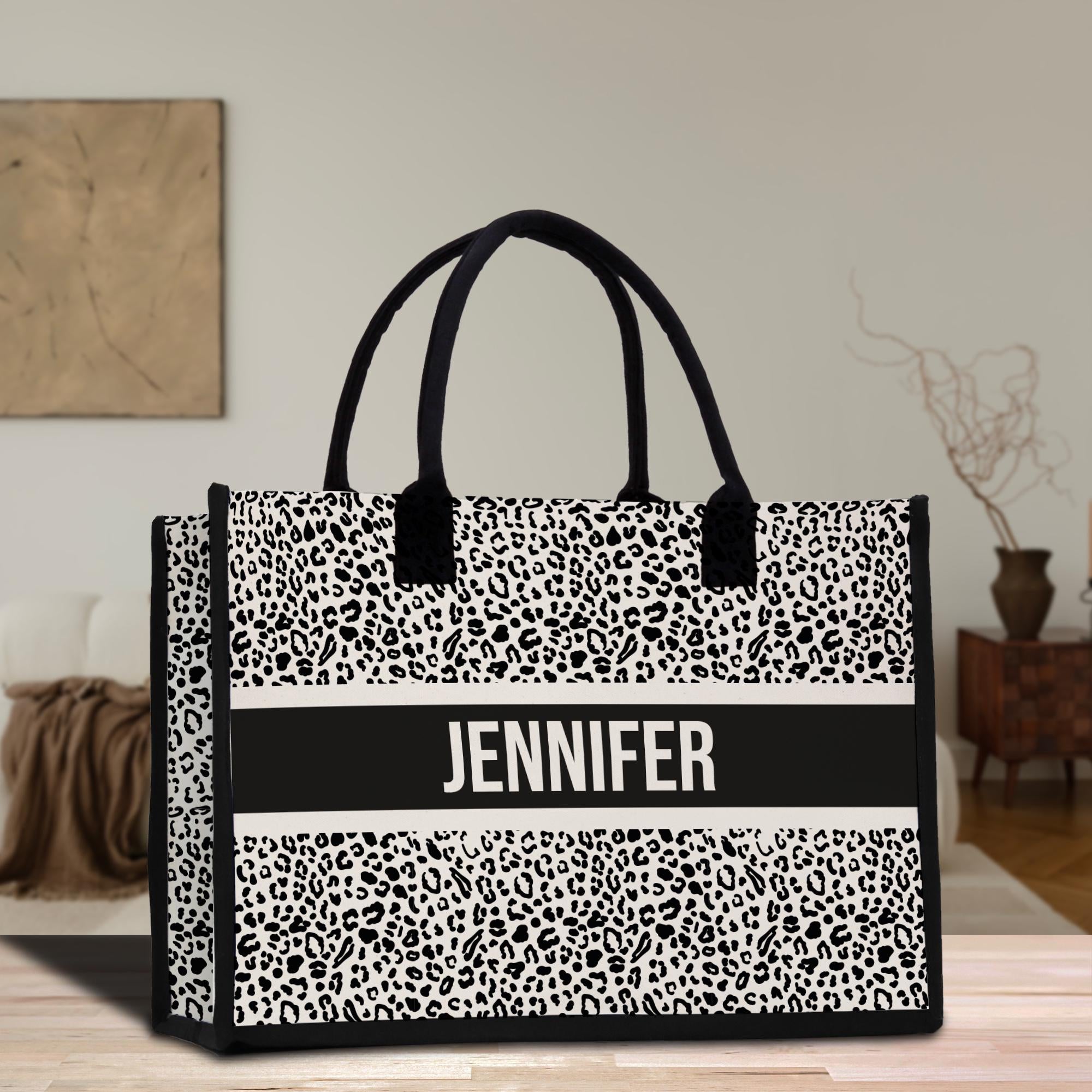 a black and white bag with a name on it