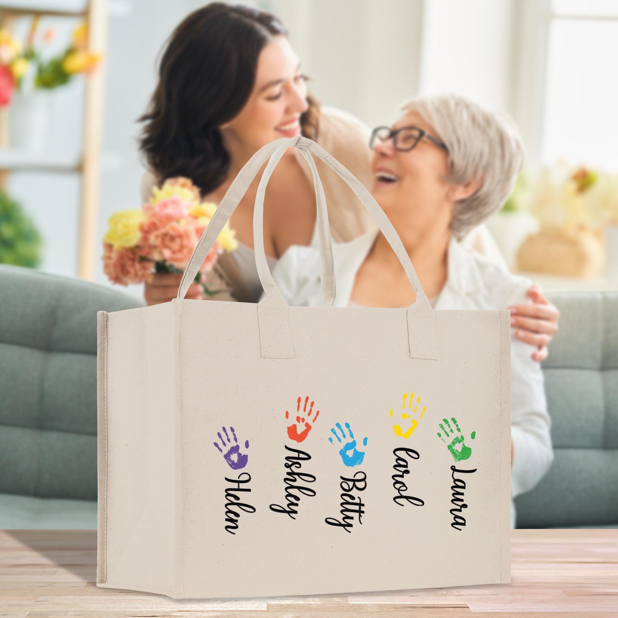 a woman holding a shopping bag with a hand print on it