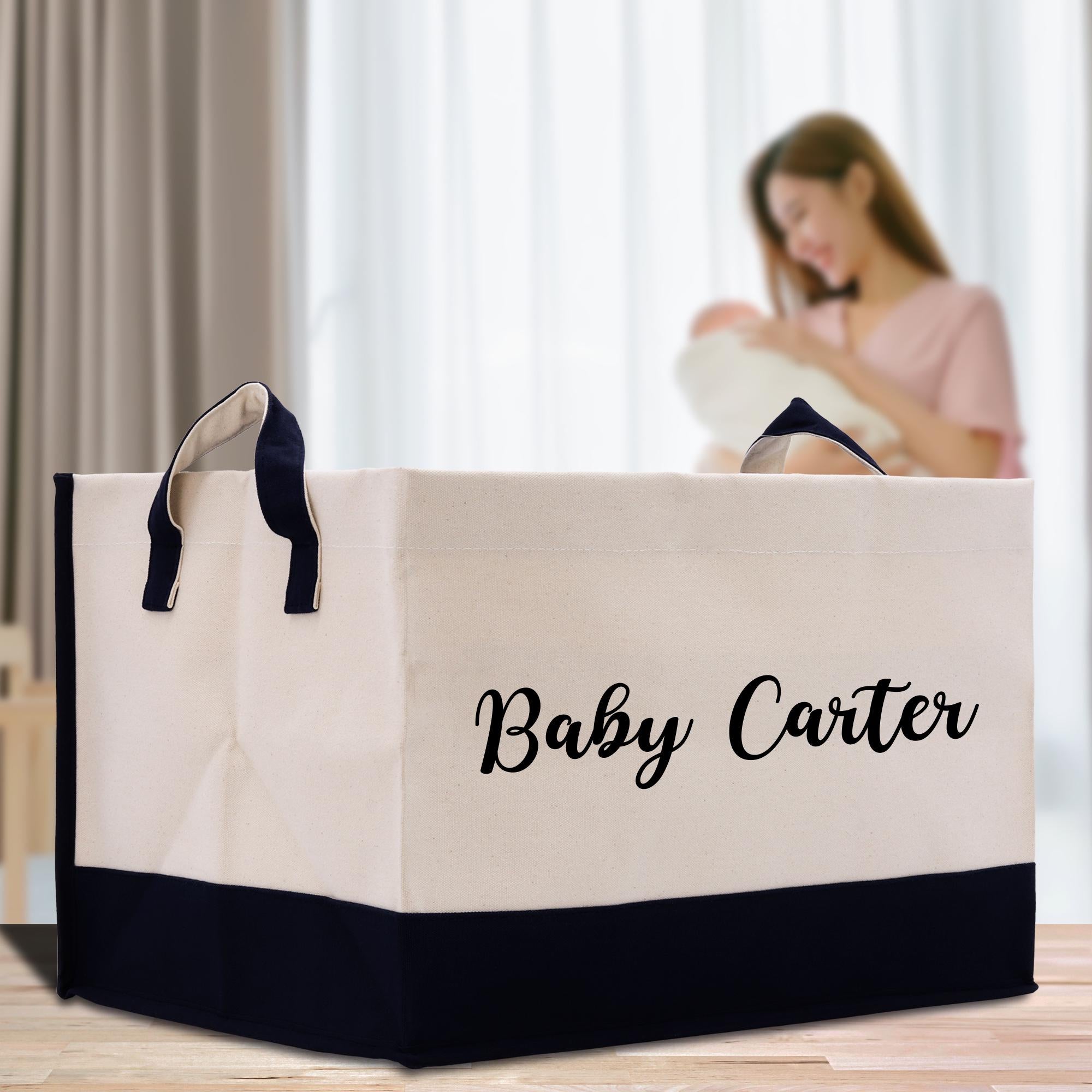 a woman holding a baby in a white and black shopping bag