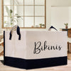 a white and black shopping bag sitting on top of a wooden table