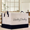 a black and white shopping bag sitting on top of a wooden table