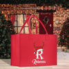 a red shopping bag with a reindeer on it