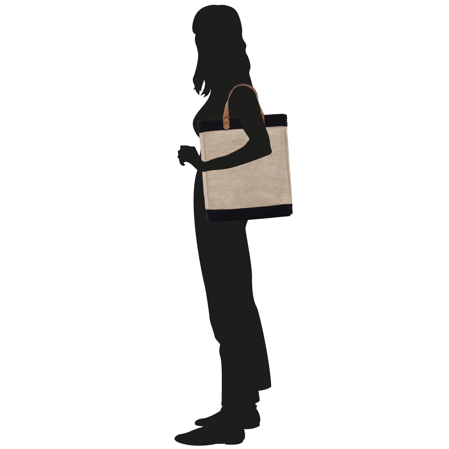 a silhouette of a woman holding a tote bag