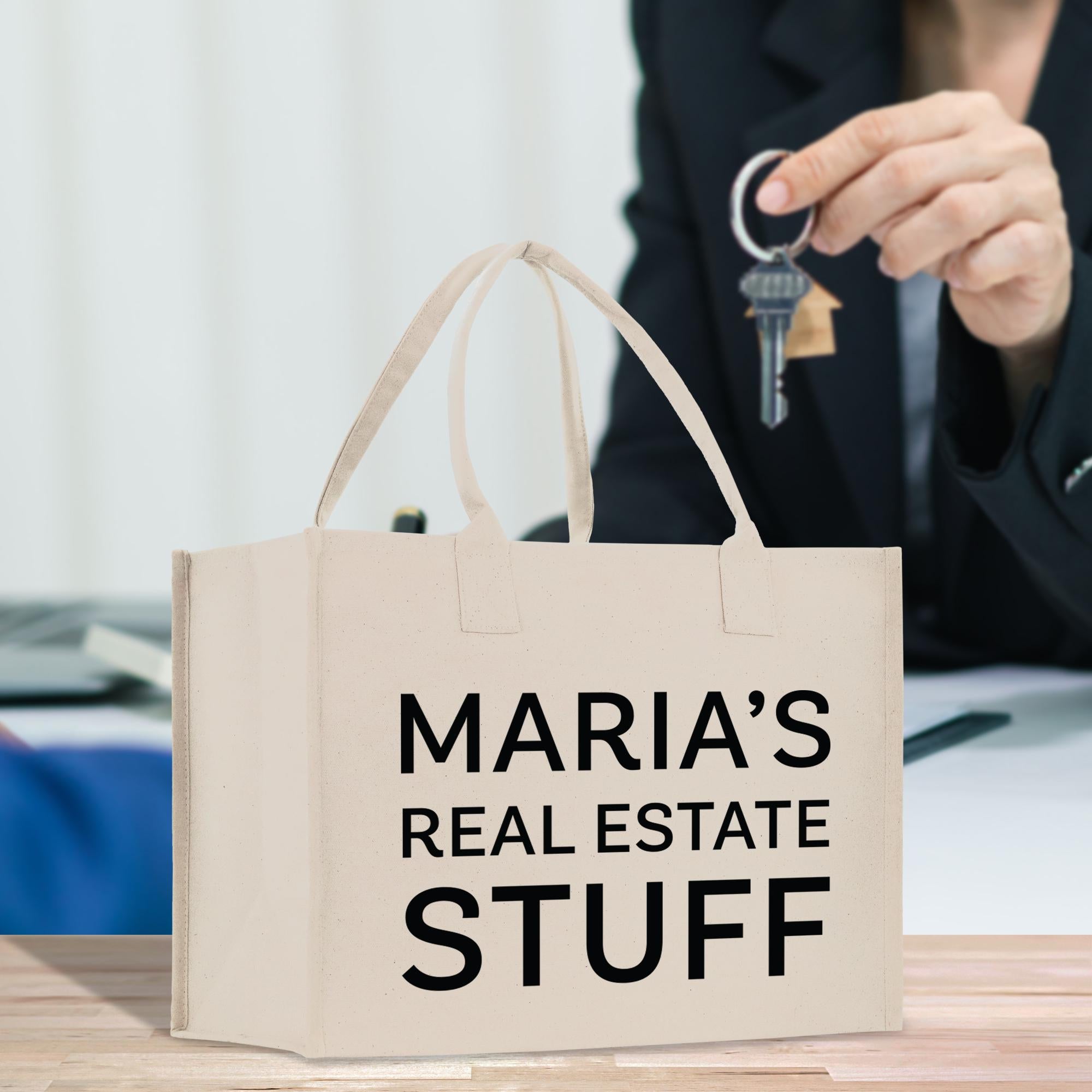 a woman holding a key to a bag that says maria&#39;s real estate stuff