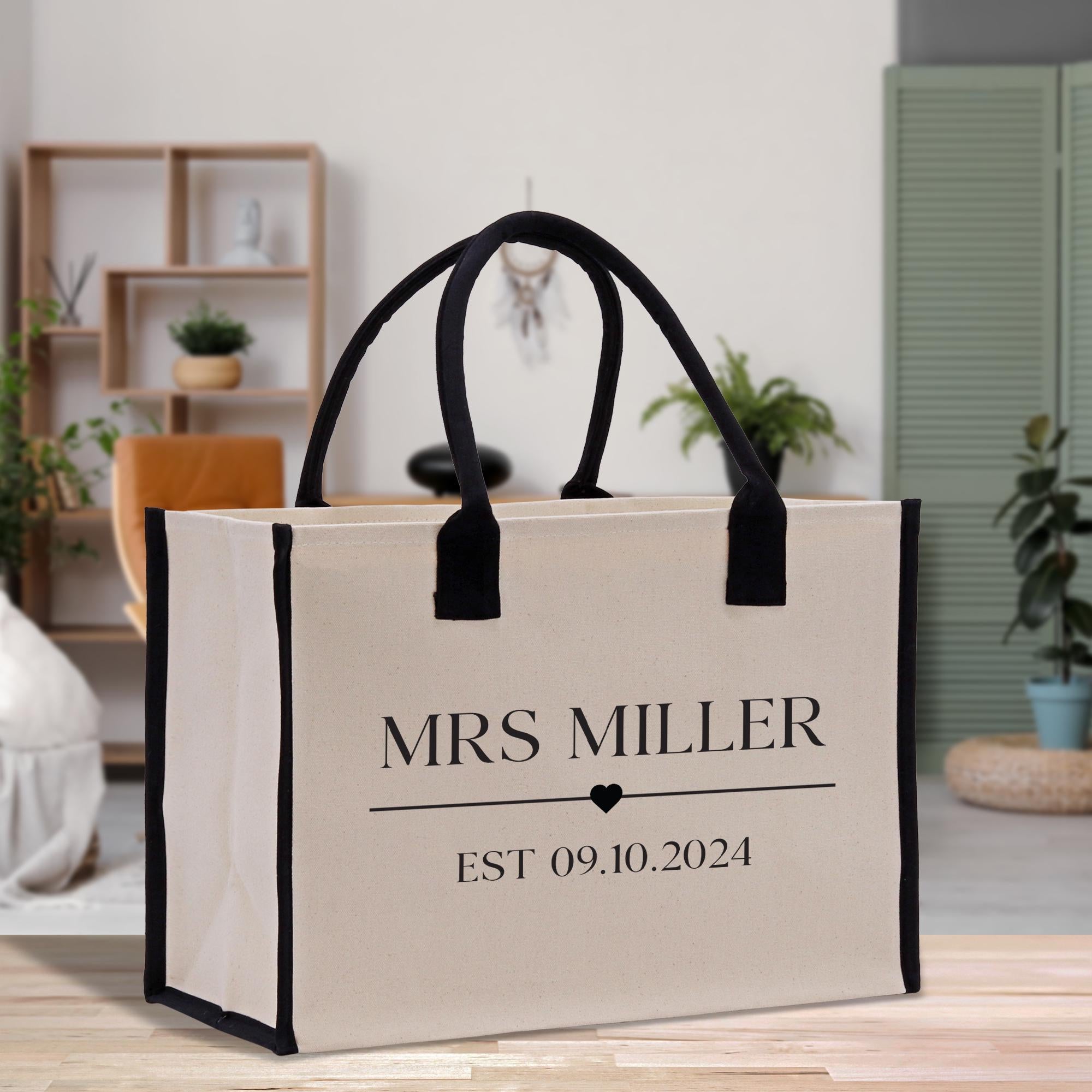 a white and black bag sitting on top of a wooden table