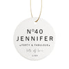 a white ceramic ornament with the words forty and fabulous written on it