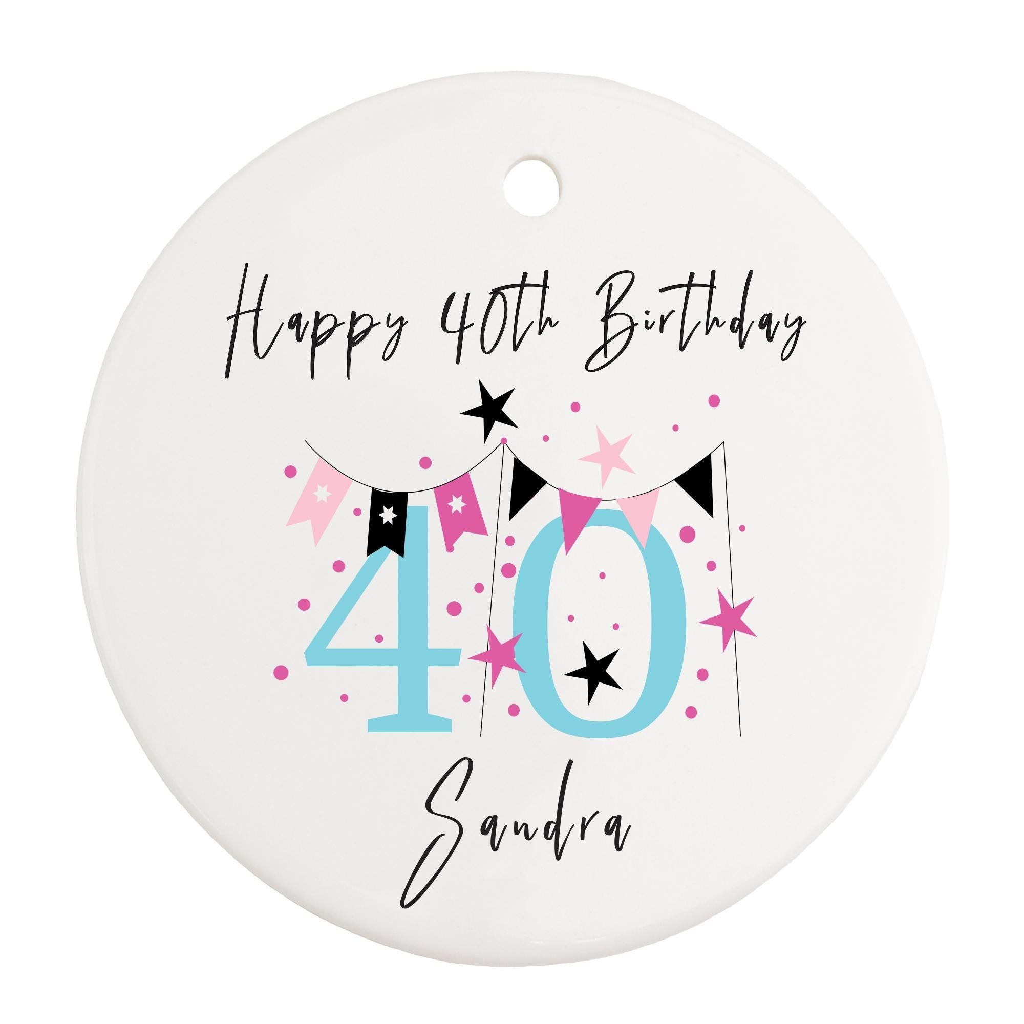 a white birthday ornament with a pink and black number forty