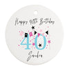 a white birthday ornament with a pink and black number forty