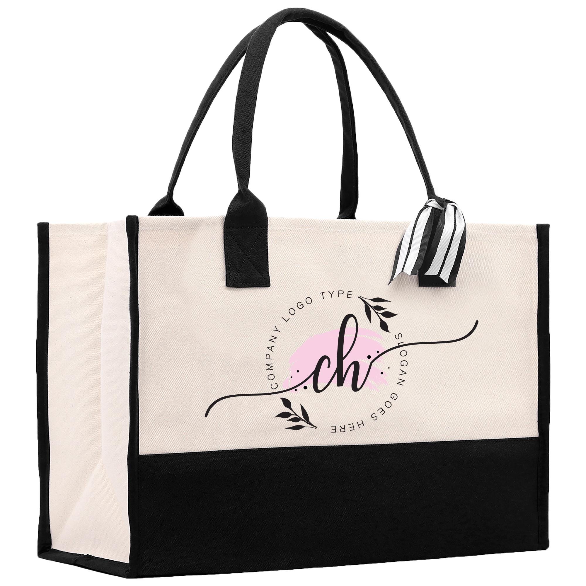 a black and white bag with a pink logo