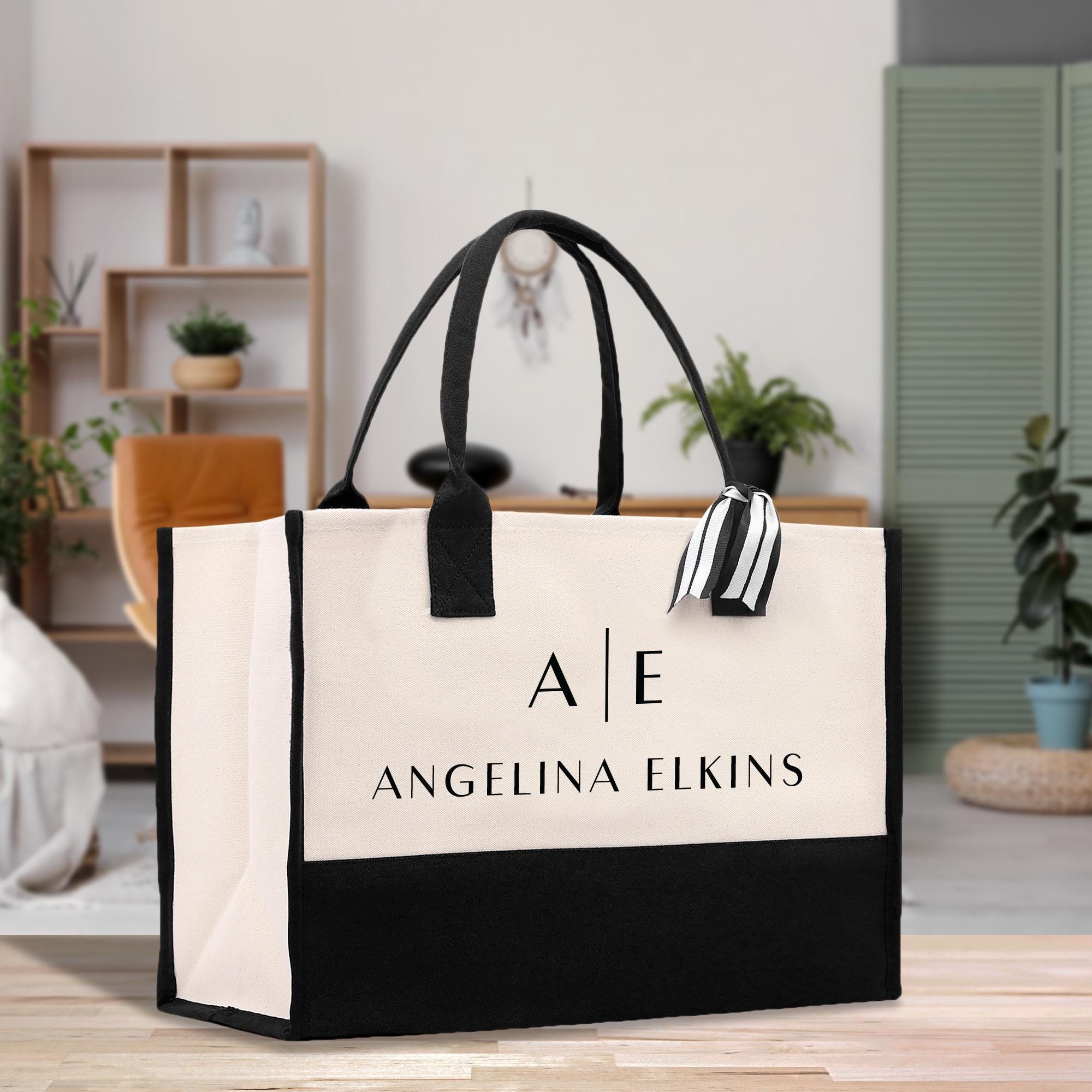 a black and white shopping bag sitting on top of a wooden table