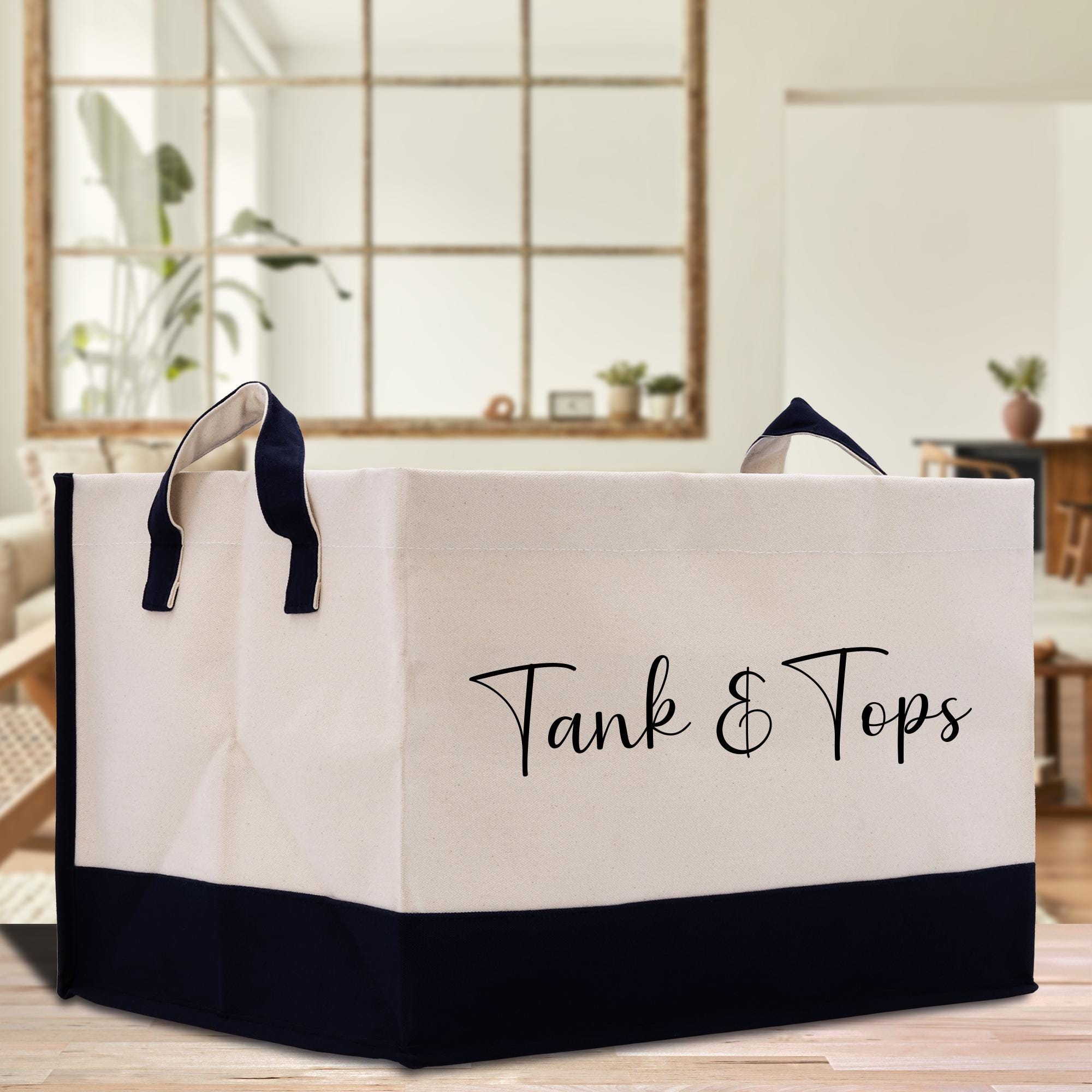 a black and white shopping bag with the words tank and tops on it