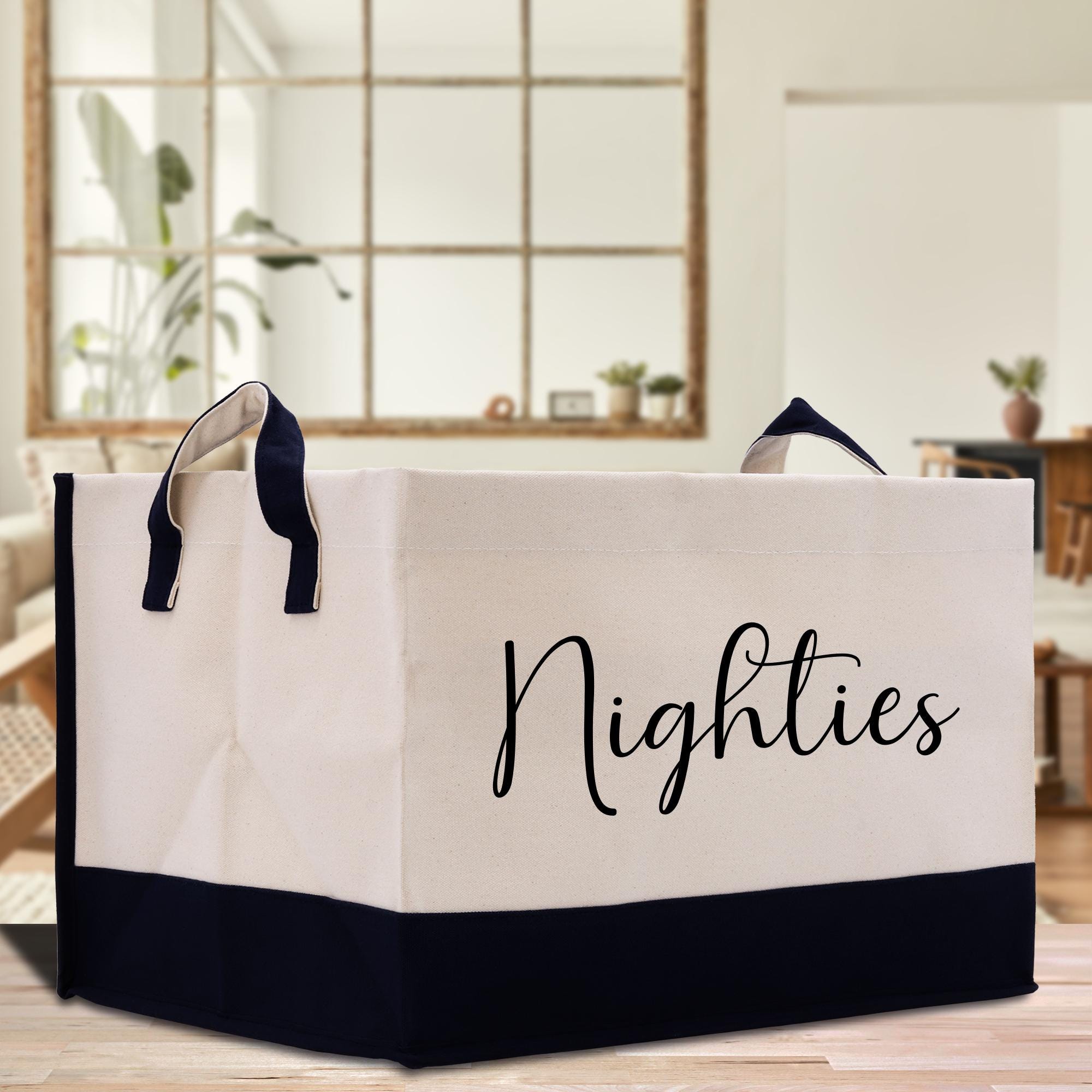 a white and black shopping bag sitting on top of a wooden table