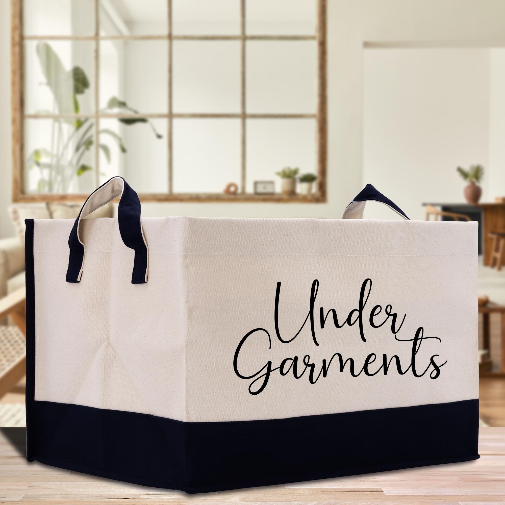 a white and black shopping bag sitting on top of a wooden table